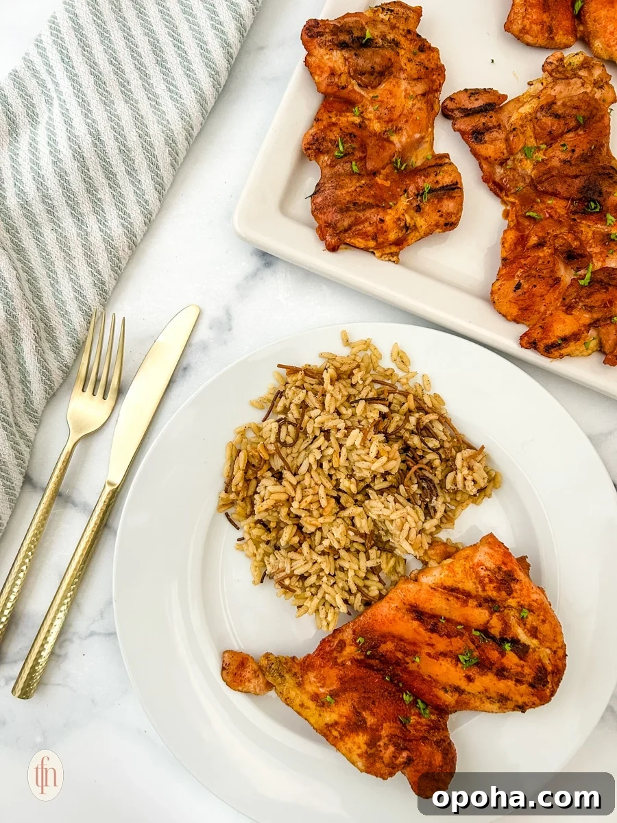 Quick Summer Dinner Recipes for Lazy Weeknights 5 Smoked chicken thigh with rice on a white plate plus a platter.