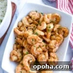 Quick Summer Dinner Recipes for Lazy Weeknights 7 Blackstone hibachi shrimp on a white platter next to a bowl of white.