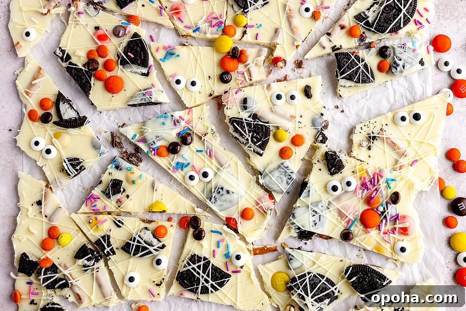 18 Spooky Halloween Movie Night Snacks to Delight Your Guests 2 White Chocolate Candy Bark with candy corn and candy eye balls on top.