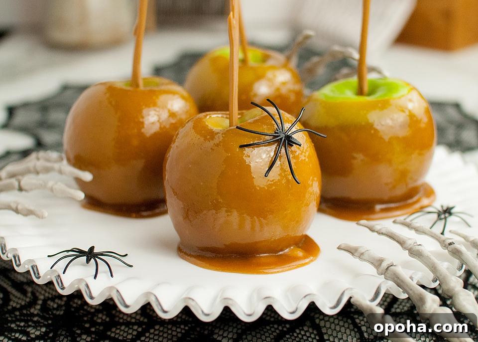 18 Spooky Halloween Movie Night Snacks to Delight Your Guests 3 Caramel apples on a white plate.