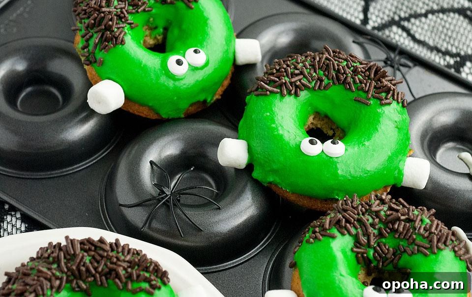 18 Spooky Halloween Movie Night Snacks to Delight Your Guests 5 Frankenstein Apple Cider Halloween Donuts with green icing on top