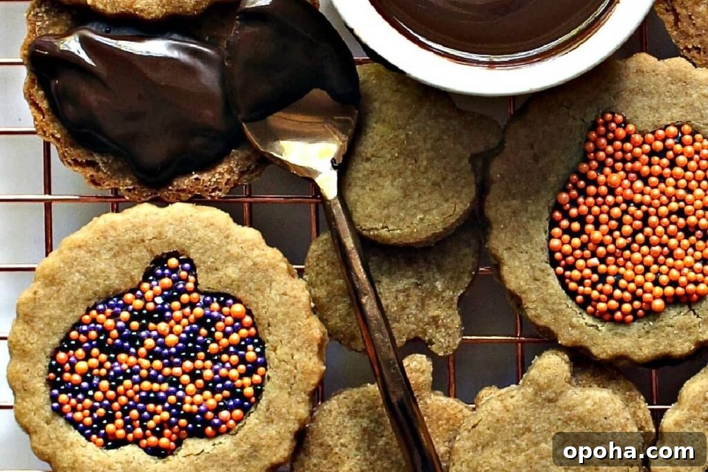 18 Spooky Halloween Movie Night Snacks to Delight Your Guests 10 Cookies with a pumpkin cut out that is filled with sprinkles.