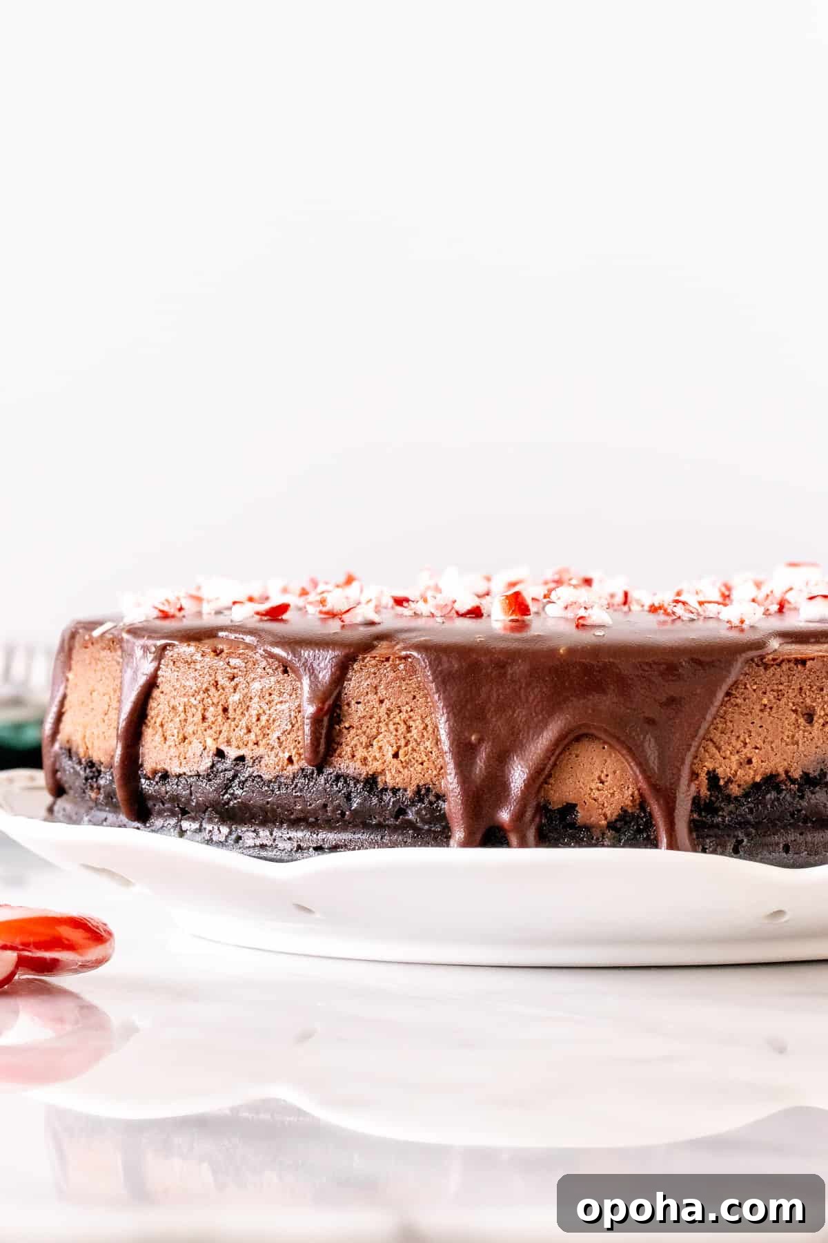 Chocolate Peppermint Cheesecake Recipe: Creamy Holiday Dessert 3 Chocolate cheesecake with chocolate on top and crushed candy canes.