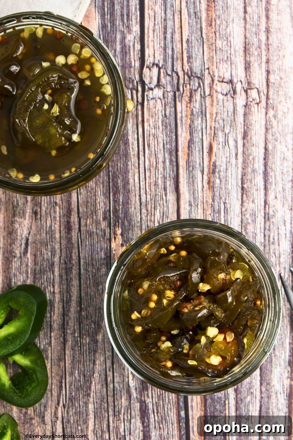 Candied Jalapeños (Cowboy Candy) Recipe for Sweet-Spicy Pickled Peppers 3 sliced jalapenos in a jar with syrup and seasonings