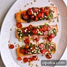 Oven-Baked Salmon with Fresh Basil Pesto 14 Plated salmon with pesto and tomatoes