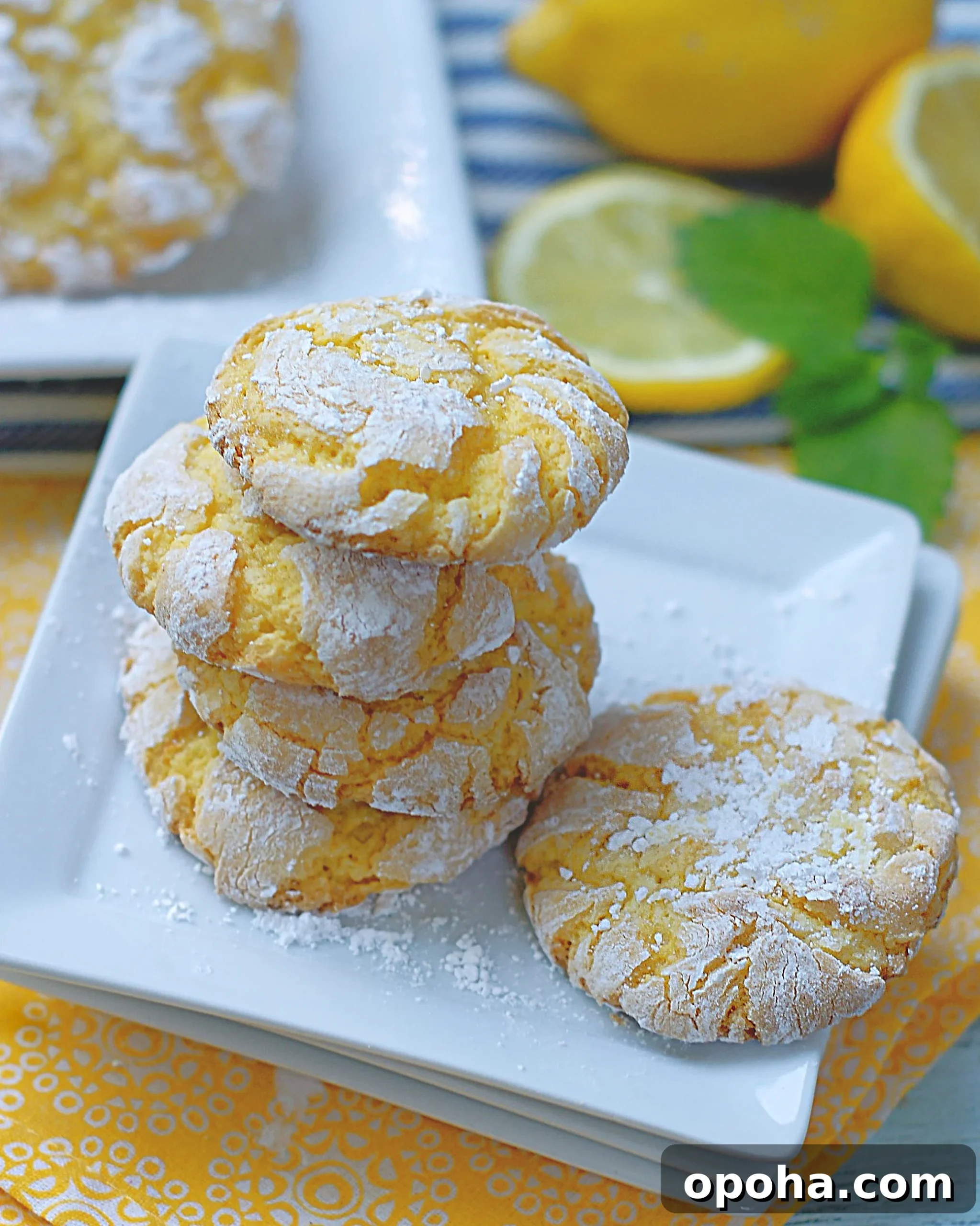Zesty Lemon Crinkle Cookies Recipe for Bright, Chewy Cookies 2 A stack of lemon crinkle cookies with powdered sugar are tart and sweet.