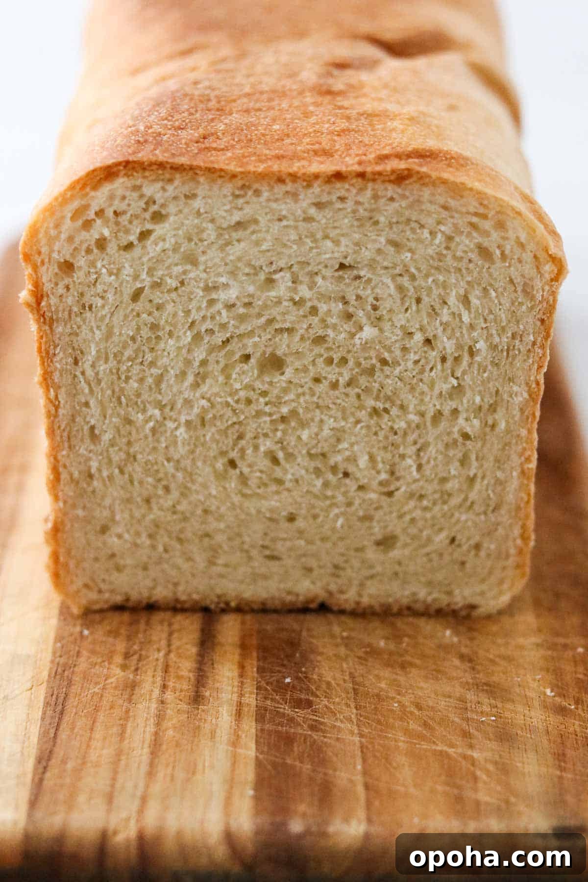 Cut loaf of Soft and Tender Buttermilk Bread.
