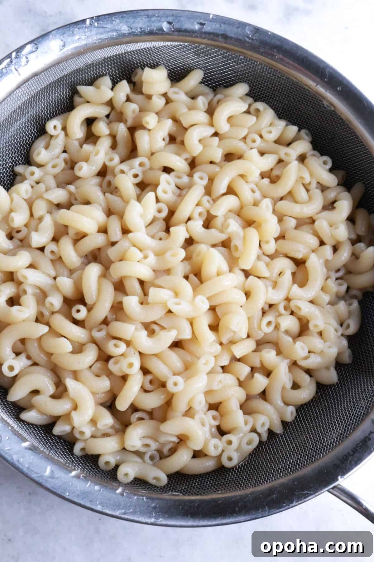 Mexican Macaroni (Ensalada de Coditos) — Creamy Cold Pasta Salad 5 Draining macaroni noodles in a sieve