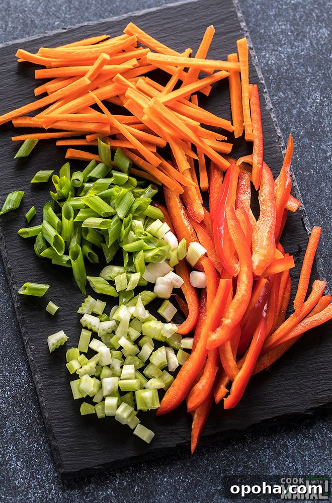 sliced vegetables like carrot, pepper on a black board