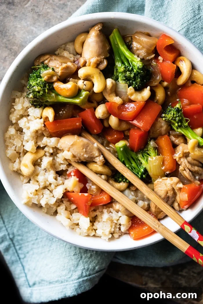 Keto & Paleo Cashew Chicken Recipe — Low-Carb Takeout Alternative 2 Paleo & keto cashew chicken with cauliflower rice and chopsticks