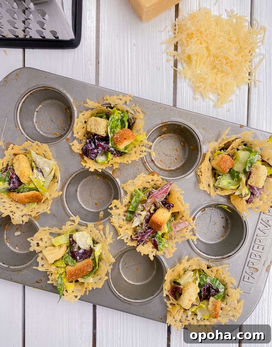 Mini Parmesan Caesar Salad Cups: Crispy Baked Appetizer 7 baked parmesan cheese cups filled with Caesar salad.
