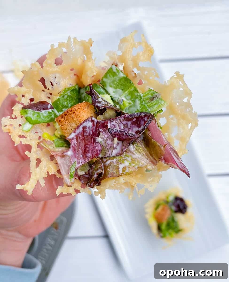 Mini Parmesan Caesar Salad Cups: Crispy Baked Appetizer 8 parmesan cups filled with Caesar salad.