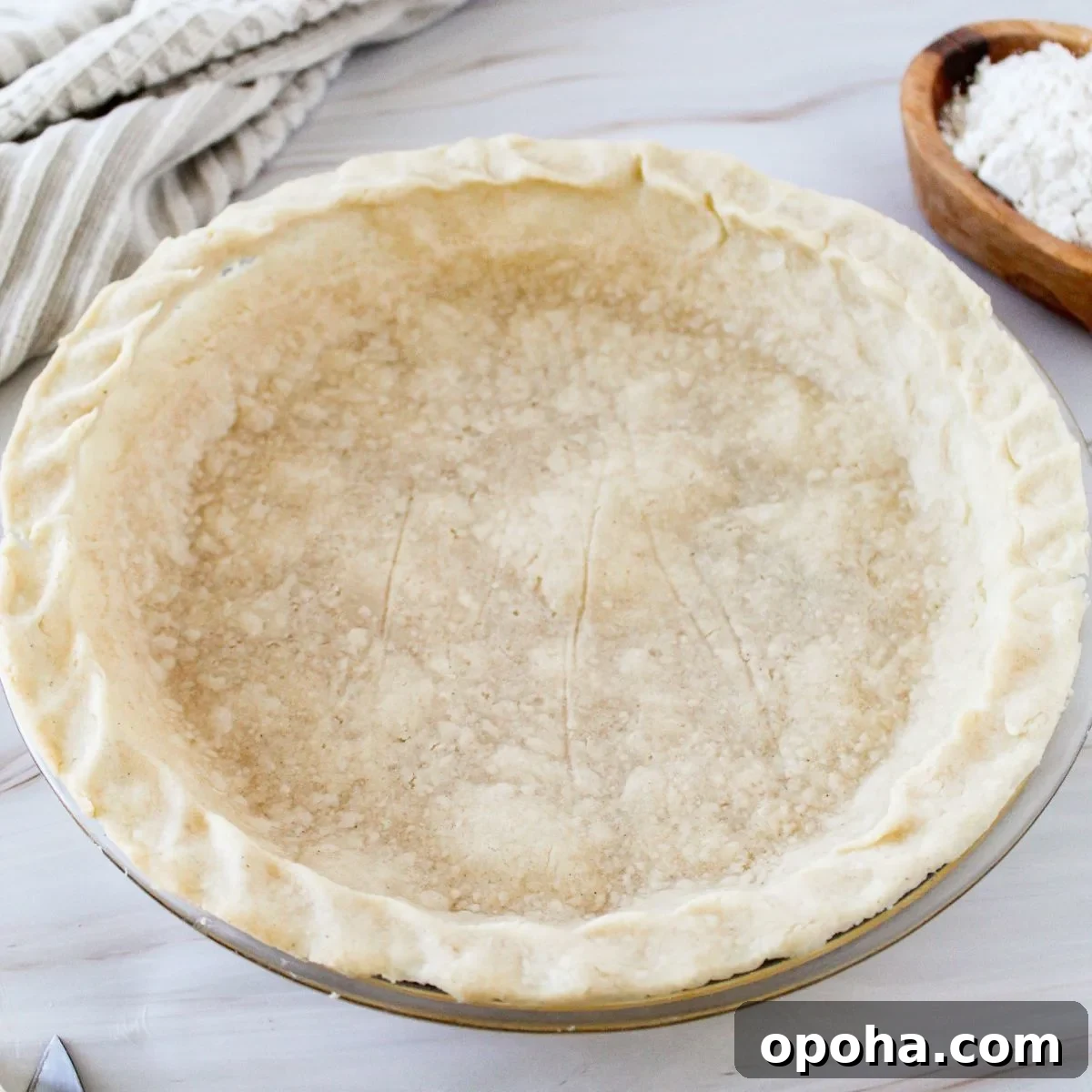 A gluten free pie crust in a pie pan.