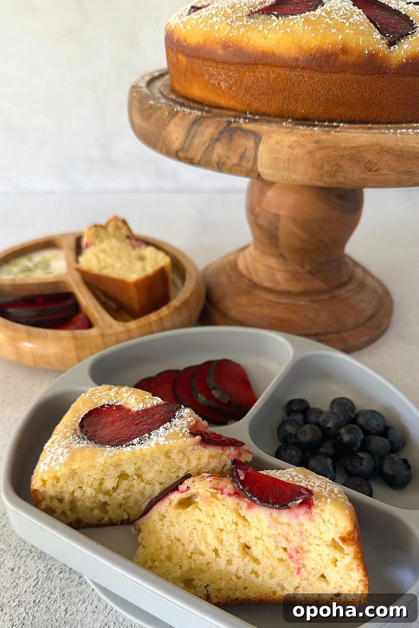 Moist Yogurt Plum Cake Recipe for Perfect Summer Baking 2 Yogurt plum cake served with fruits.