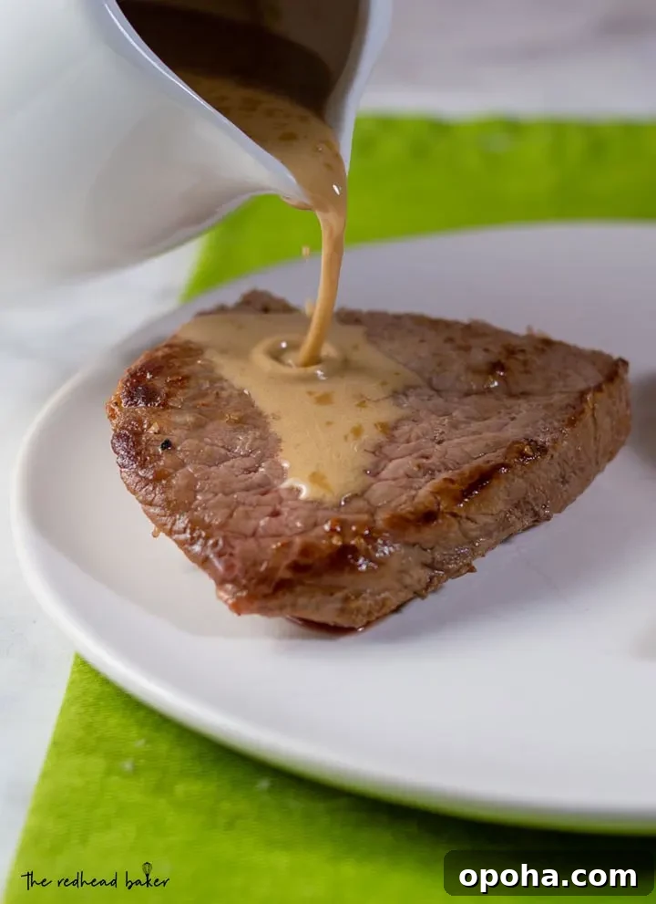 Whiskey Sauce Steak Recipe: Pan-Seared Steak with Rich Whiskey Glaze 4 Whiskey sauce being poured onto a piece of steak