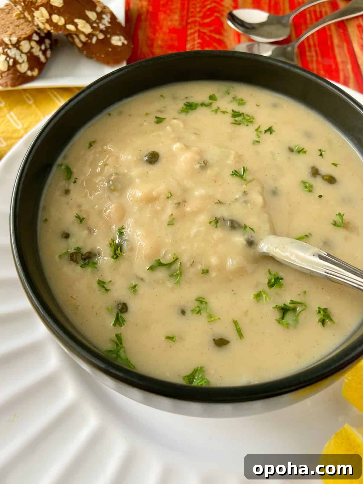 Velvety White Bean Soup with Garlic and Herbs 8 Close up image of white bean soup garnished with fresh parsley.