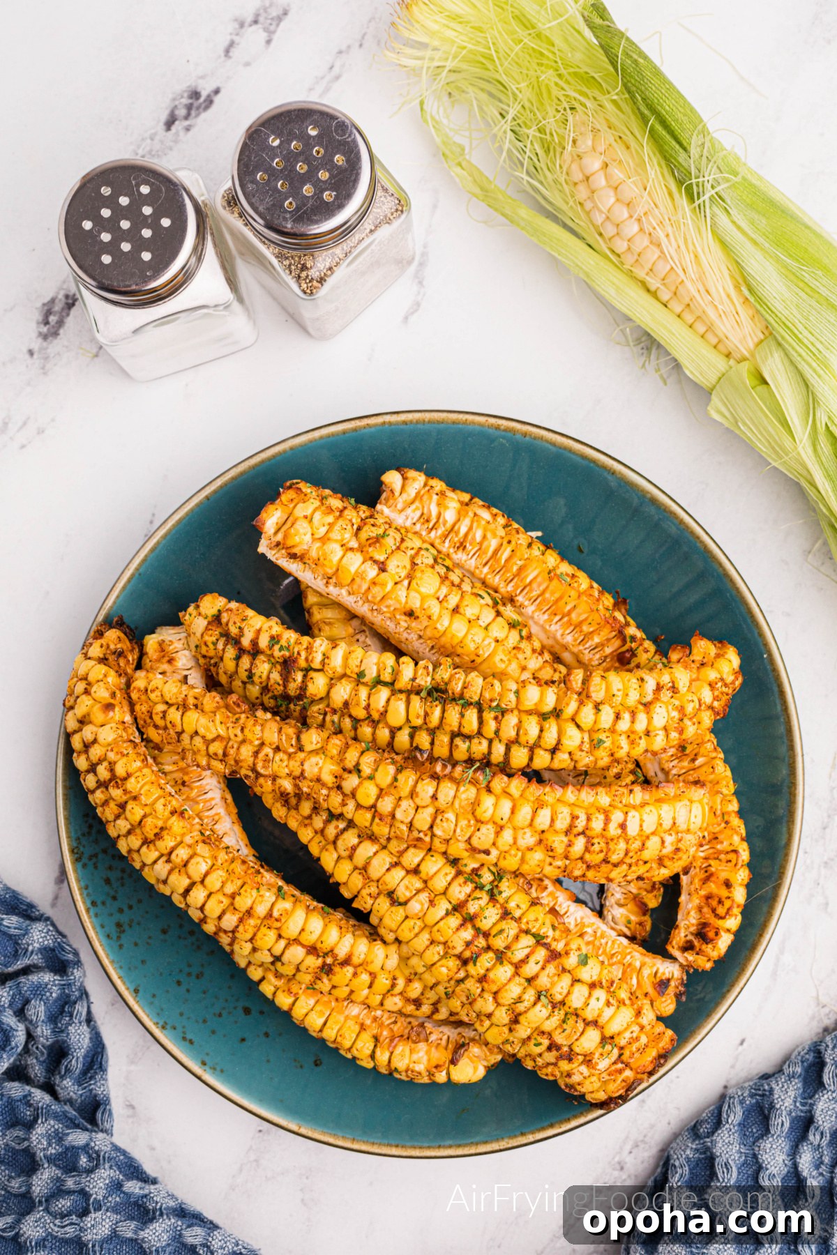 Crispy Air Fryer Corn Ribs Recipe 4 Corn ribs made in the air fryer and served on a plate, ready to eat.