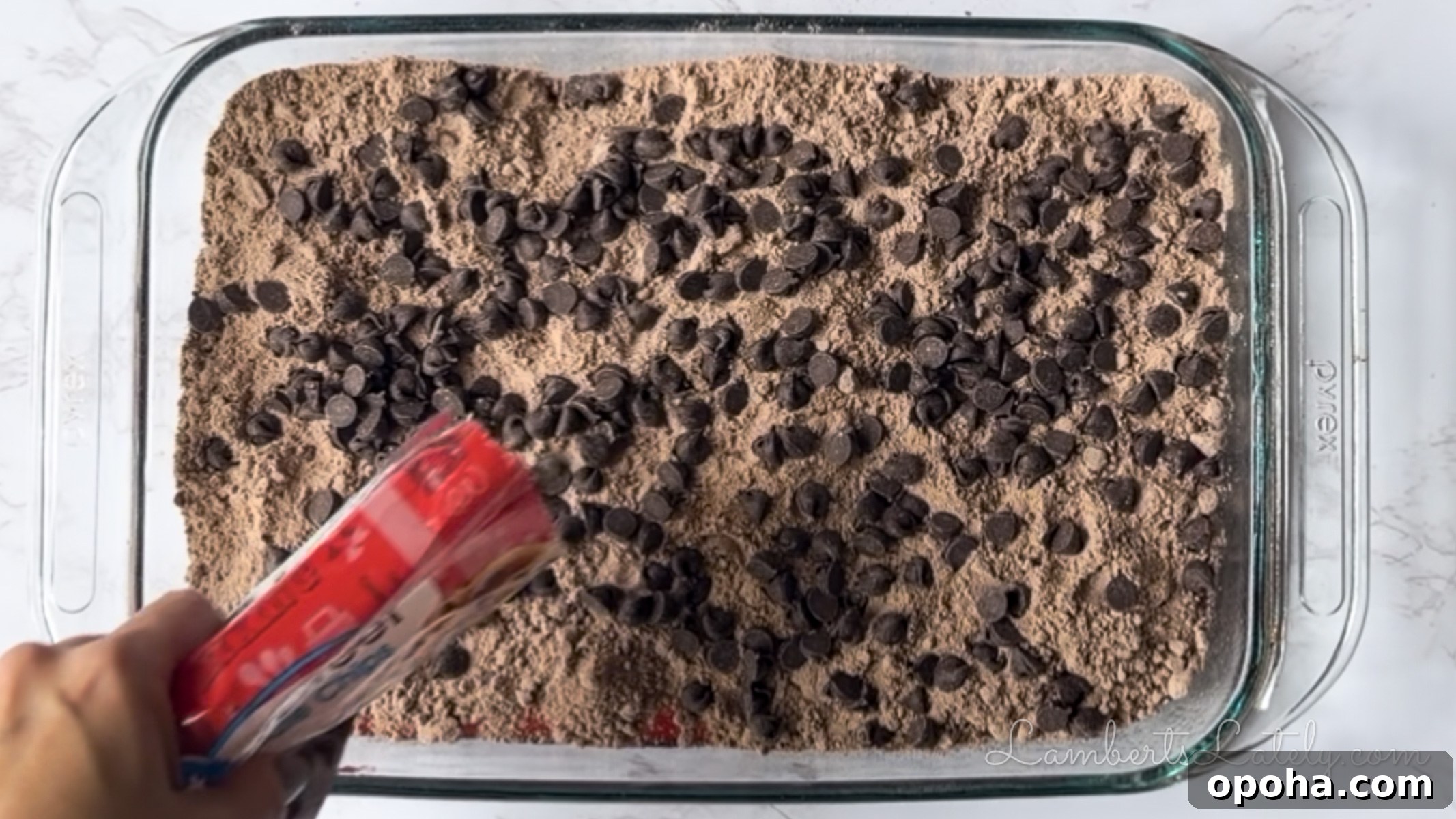 Decadent Chocolate Cherry Dump Cake Recipe for Chocolate Lovers 8 pouring chocolate chips over brownie mix.