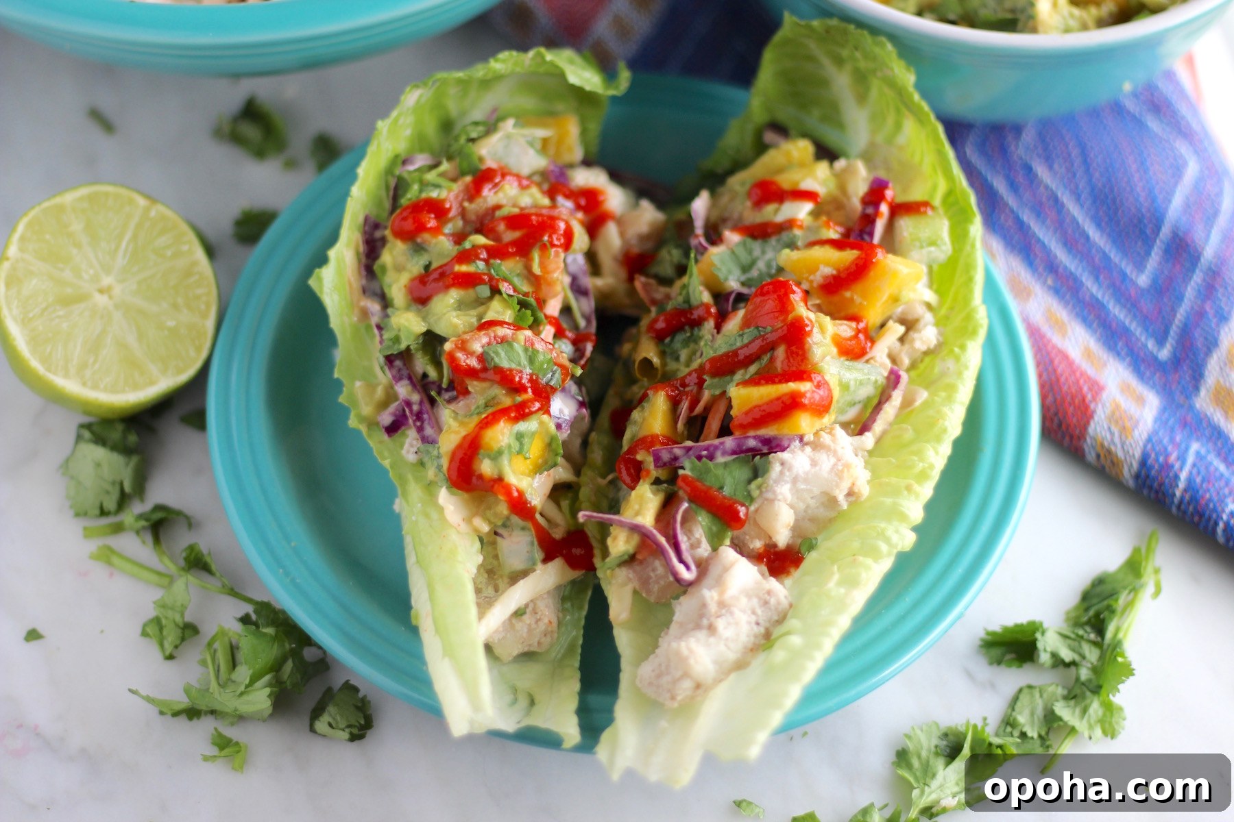 Maui Fish Tacos - a sweet and spicy lettuce wrap taco featuring Hawaiian and Mexican flavors from juicy mango guacamole and sriracha coconut milk slaw! | fedandfulfilled.com
