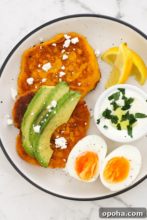 Crispy Pumpkin Fritters with Maple Cinnamon Glaze 11 two pumpkin fritters on a white plate topped with feta and avocado.
