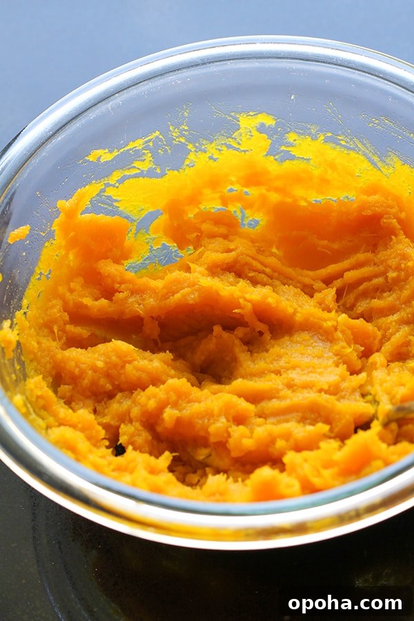 Crispy Pumpkin Fritters with Maple Cinnamon Glaze 6 mashed pumpkin in a glass bowl.