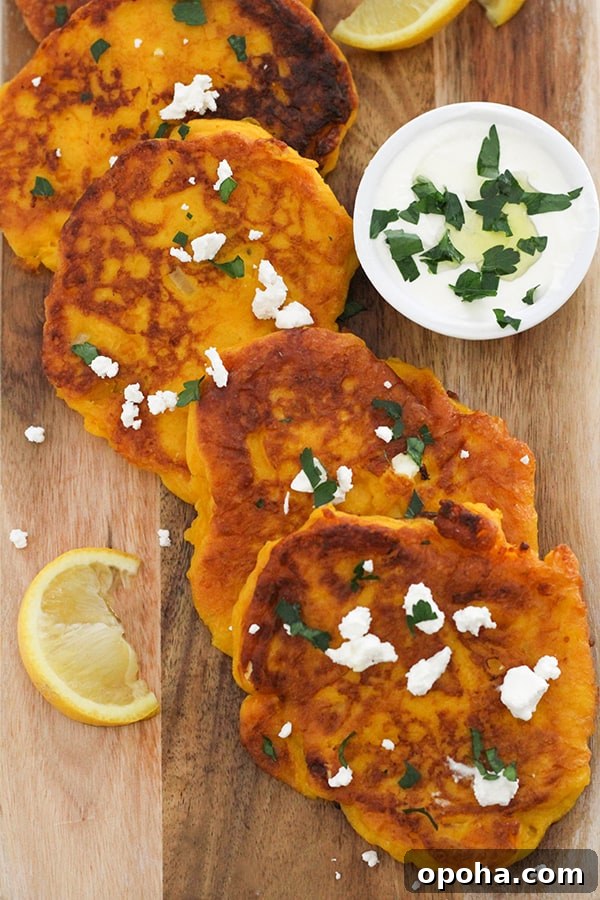 Crispy Pumpkin Fritters with Maple Cinnamon Glaze 10 pumpkin fritters laid on top of a wooden board.