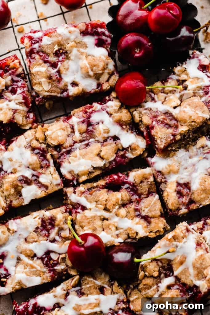 Chewy Cherry Pie Bars with Buttery Crust Recipe 3 Cherry Pie bars sliced with a glaze on top.
