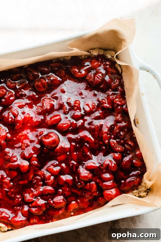 Chewy Cherry Pie Bars with Buttery Crust Recipe 7 Cherry pie filling over the base of the bars.