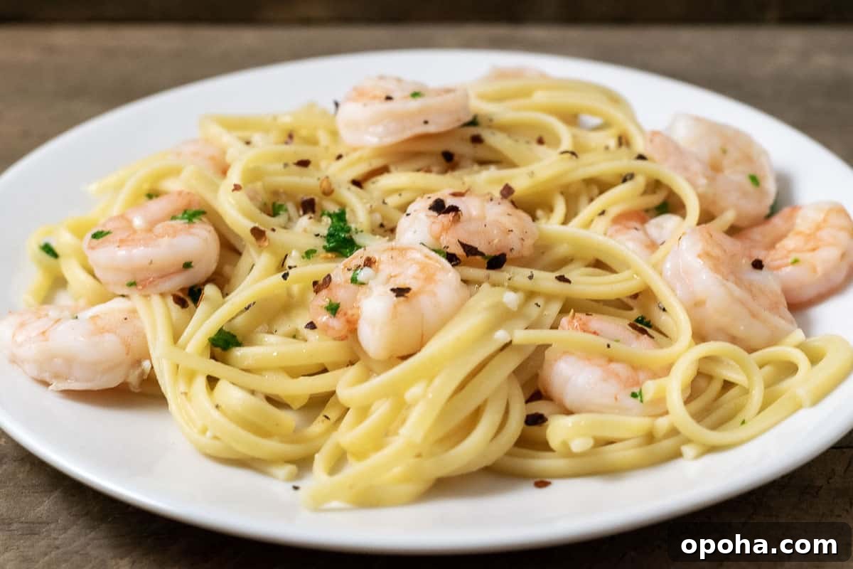 Shrimp Scampi and Pasta sprinkled with seasonings on a plate