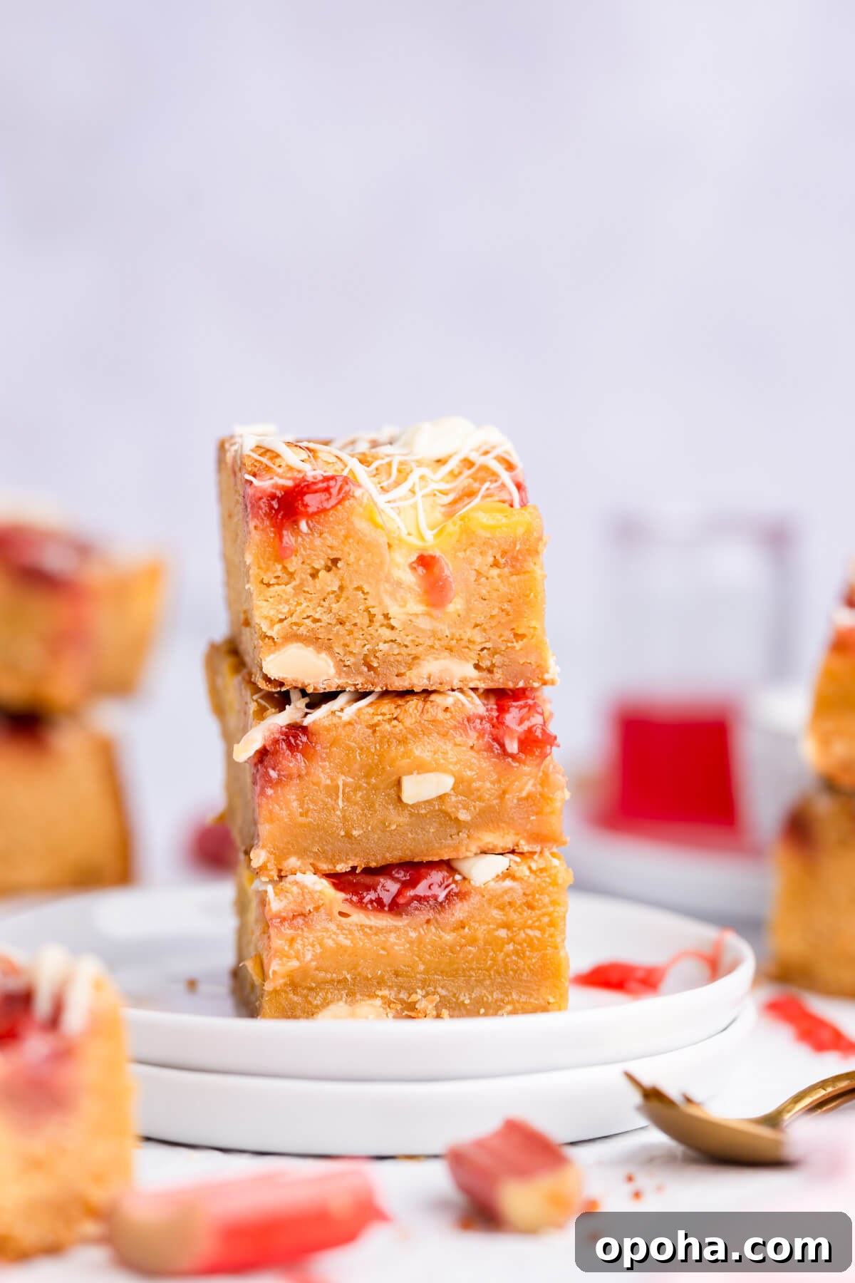 Rhubarb and Custard Blondies Recipe 2 side close up shot of three rhubarb blondies stacked on top of each other
