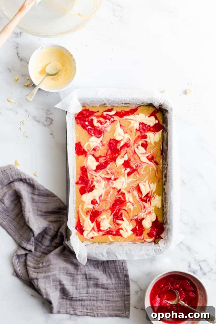Rhubarb and Custard Blondies Recipe 12 top view of cake batter topped with rhubarb and custard