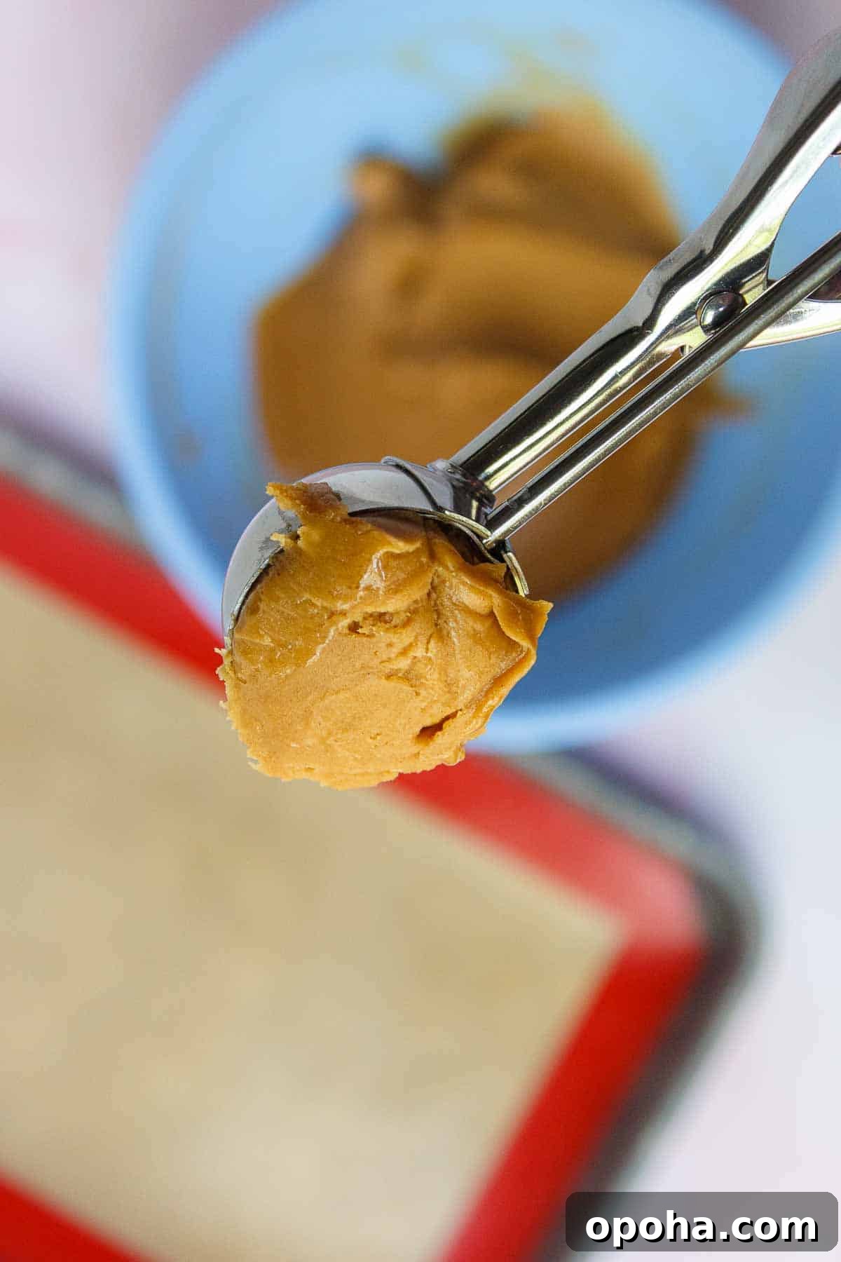 3-Ingredient Peanut Butter Blossom Cookies — Quick Holiday Treat 6 A tablespoon-size cookie scoop that is filled with cookie batter and slightly rounded.