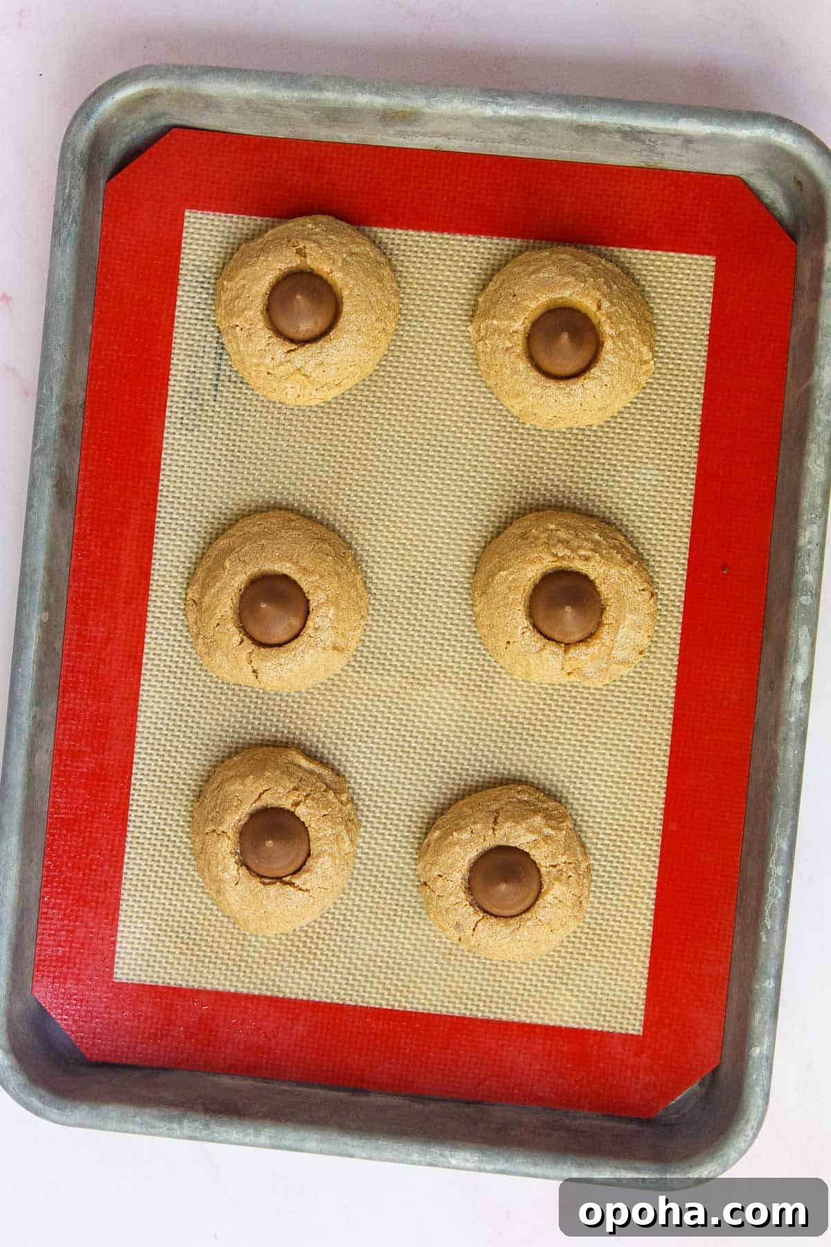 3-Ingredient Peanut Butter Blossom Cookies — Quick Holiday Treat 8 Baked peanut butter cookies with a Hershey Kiss pressed into the center of each cookie