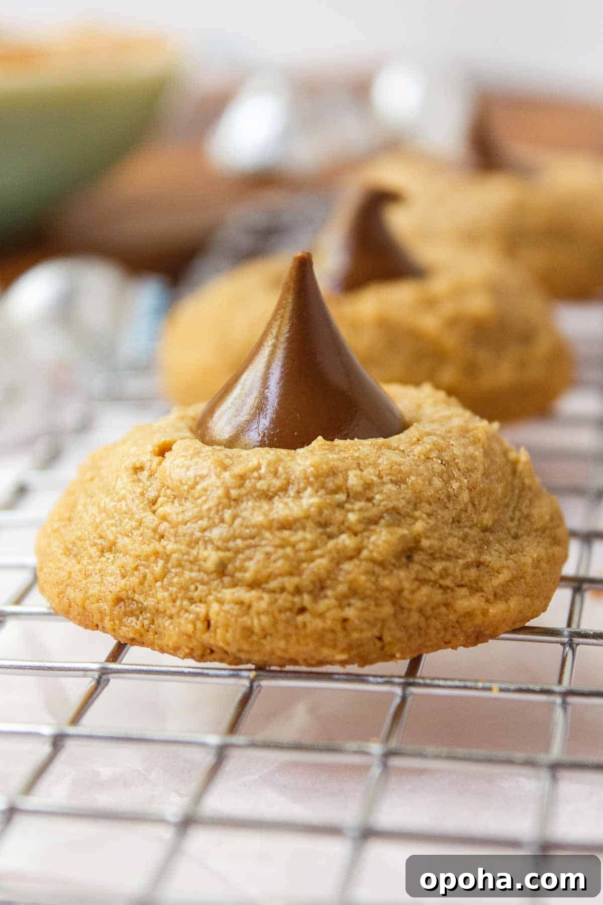 3-Ingredient Peanut Butter Blossom Cookies — Quick Holiday Treat 9 Peanut butter blossom cookie cooling on a wire rack