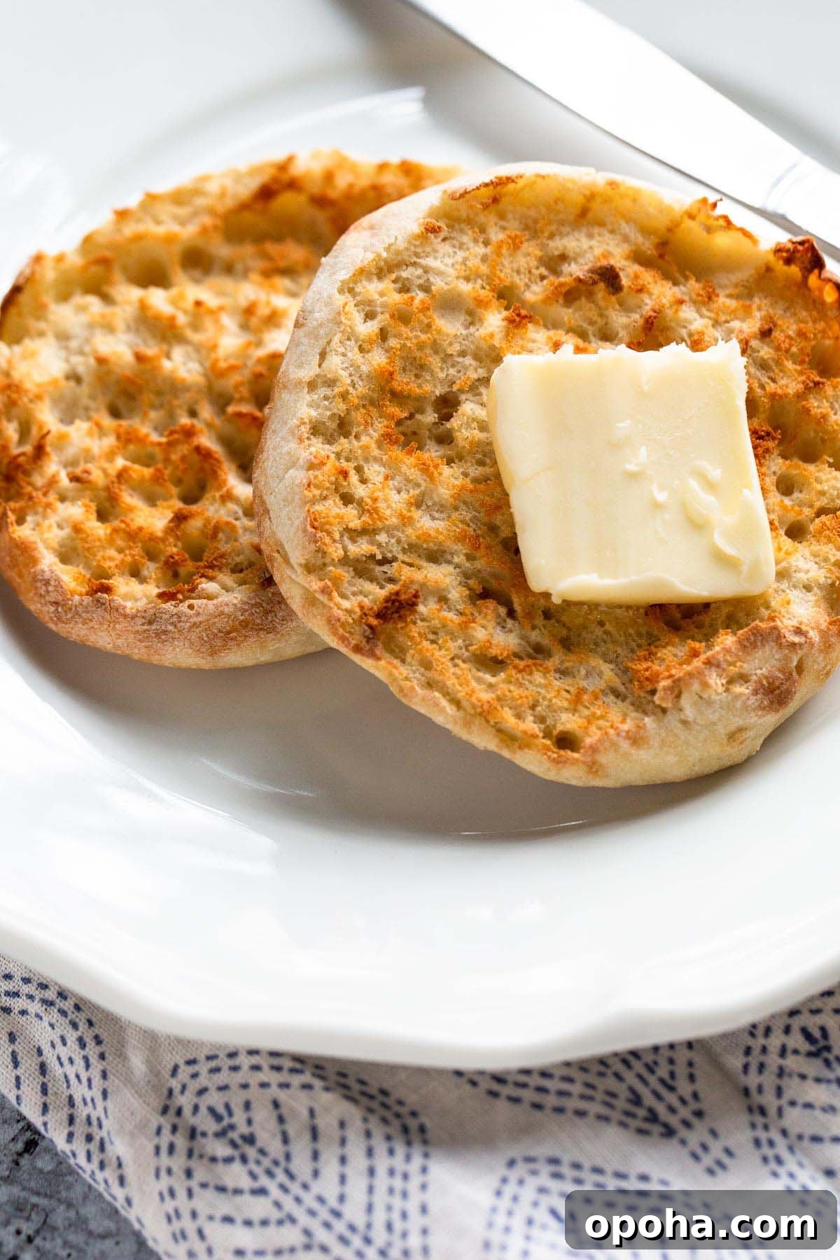 Crispy Air Fryer English Muffins Recipe 2 Toasted English muffin with butter.