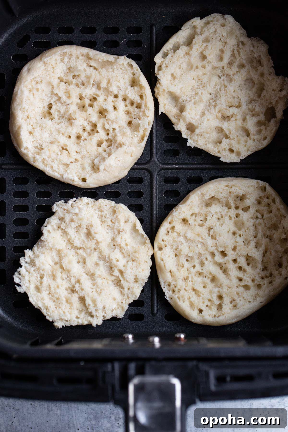 Crispy Air Fryer English Muffins Recipe 4 Untoasted English muffin in air fryer basket.