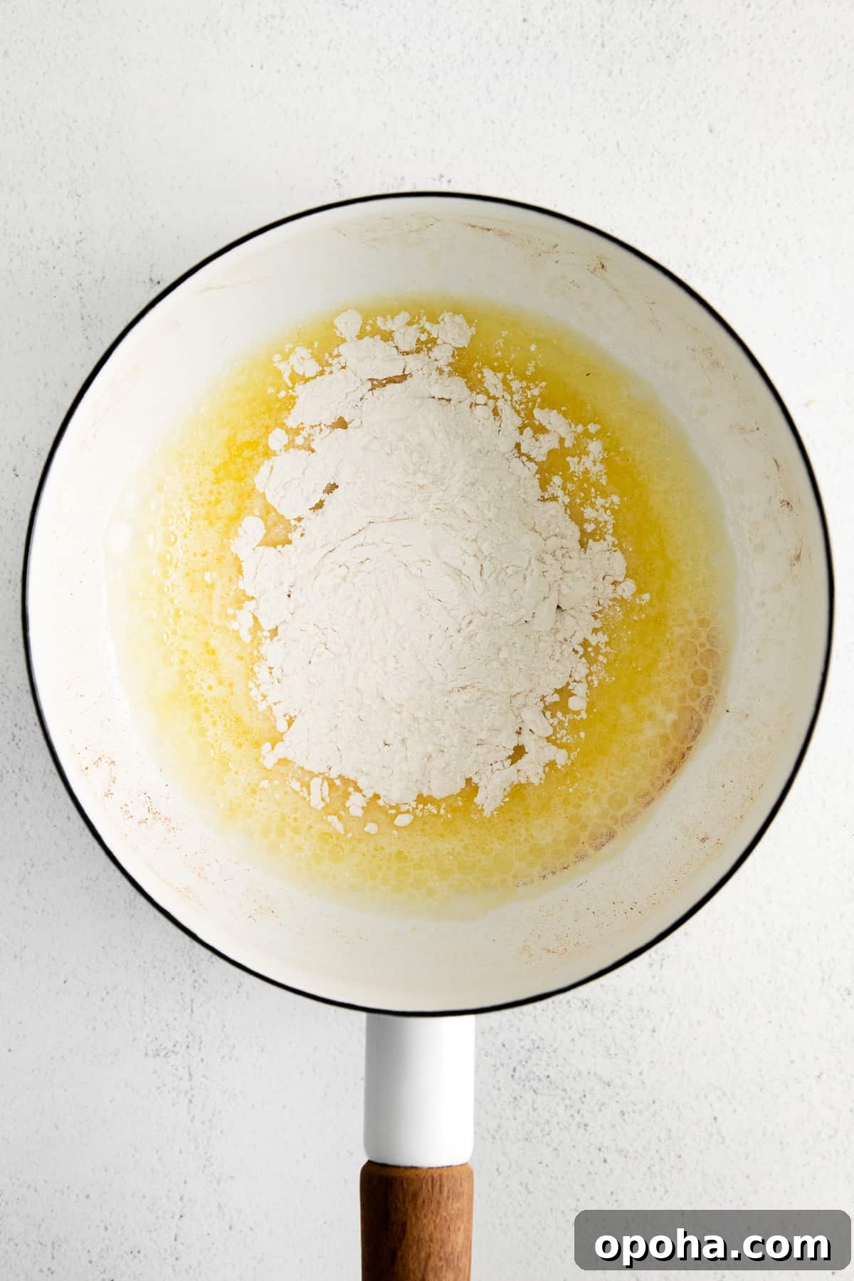 Looking for a classic cheddar cheese sauce recipe? This cheese sauce is perfect for dipping chips, topping veggies, or mixing with noodles. It's truly an all-purpose sauce. making roux in pot.