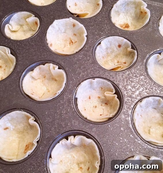 pressing tortilla circles into a muffin tin.