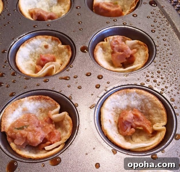 Refried beans in bottom of tostada cups