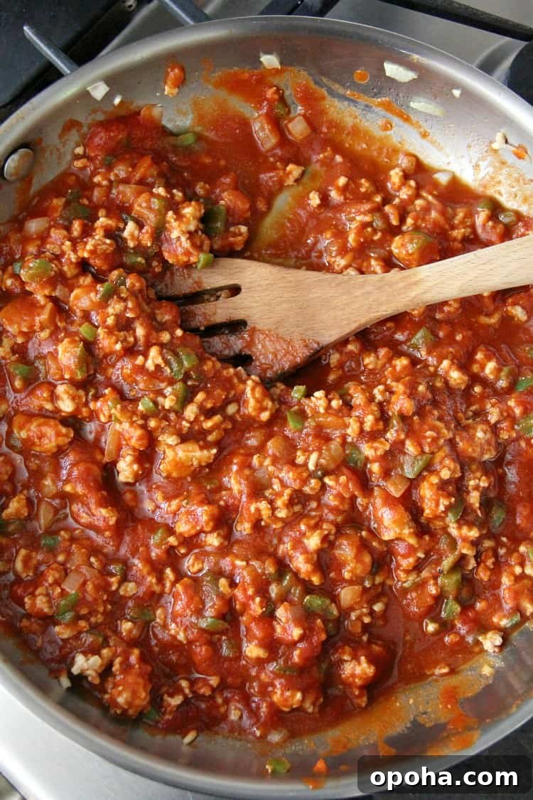Italian Sloppy Joes easy dinner recipe with chicken, tomato sauce, onions, and peppers chicken sloppy joe mixture in pan