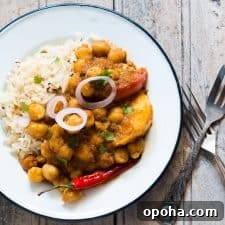 120+ Delicious Vegetarian Diwali Recipes to Try This Year 57 A picture of the curry plated with rice and onions.