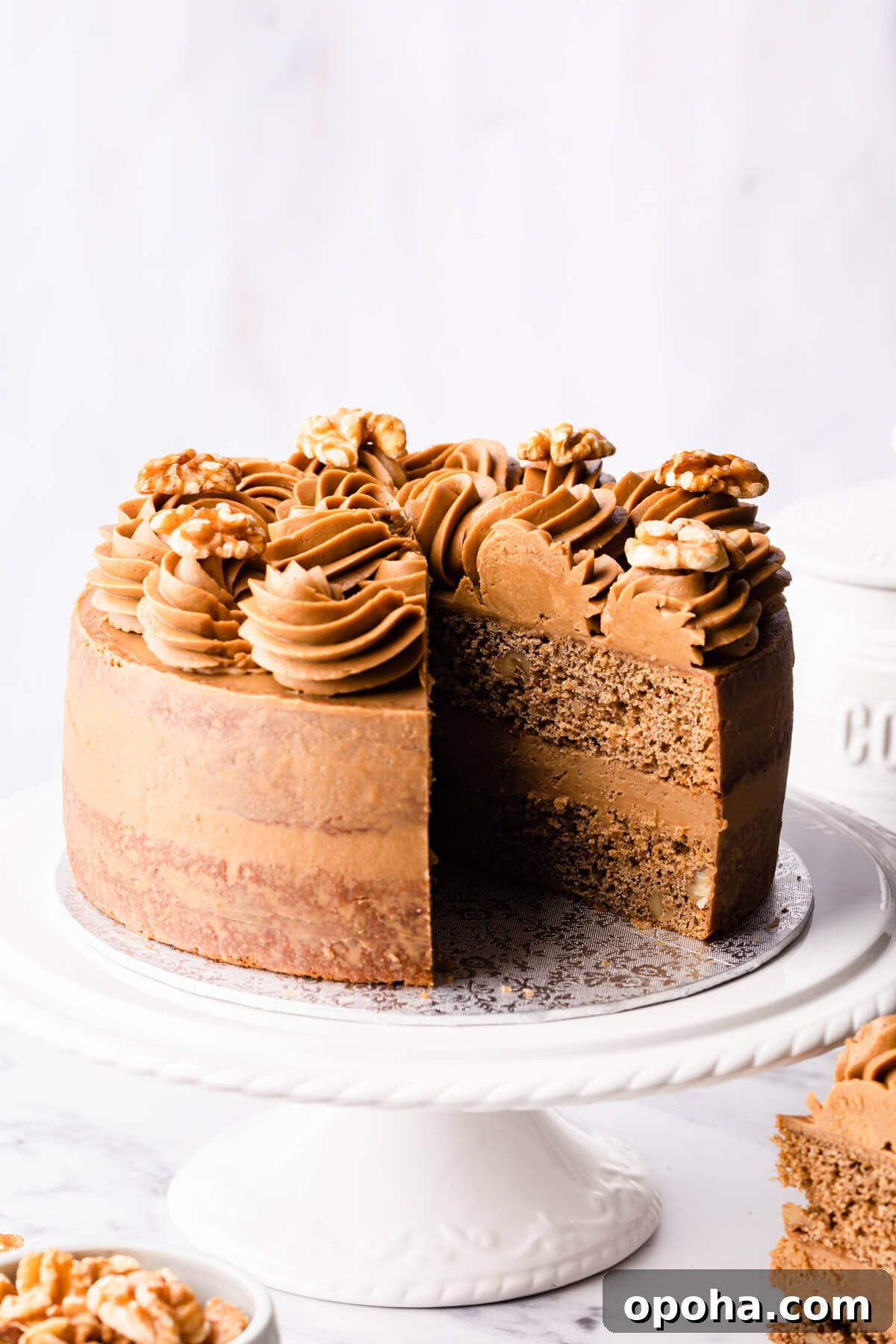 Decadent Coffee and Walnut Cake Recipe for Coffee Lovers 11 walnut and coffee cake with a slice cut out of it.