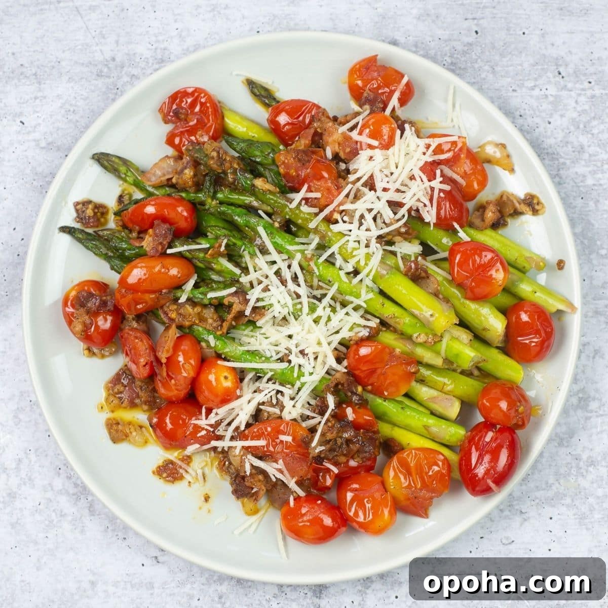 Sautéed Asparagus, Tomatoes & Bacon Skillet Recipe 2 Sautéed asparagus with tomatoes and bacon on a plate.