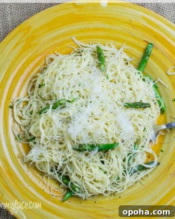 A yellow plate with a serving of Garlic Asparagus Pasta.