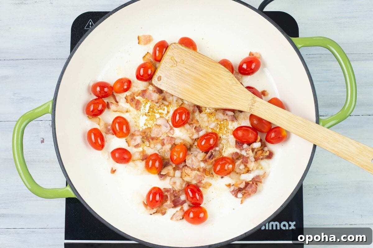 Sautéed Asparagus, Tomatoes & Bacon Skillet Recipe 6 Tomatoes and onion added to bacon in skillet.