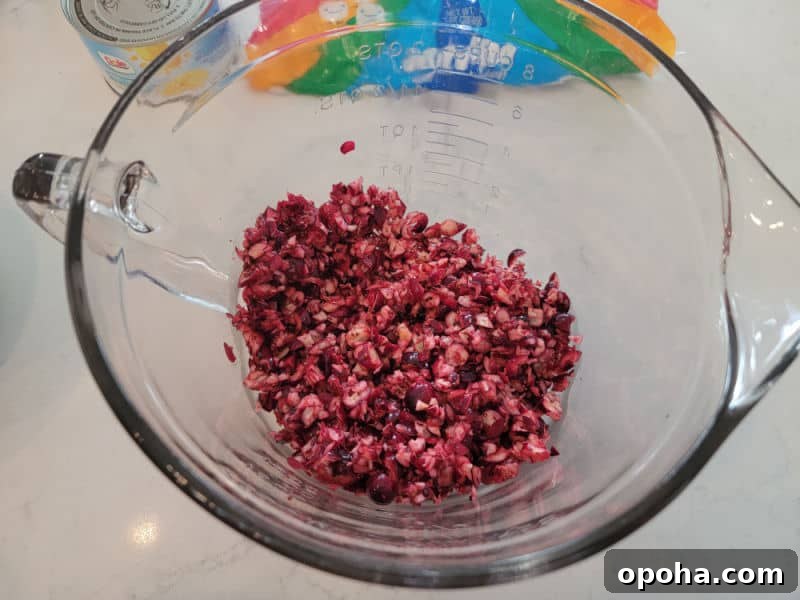 shredded cranberries in a glass bowl for cranberry fluff salad