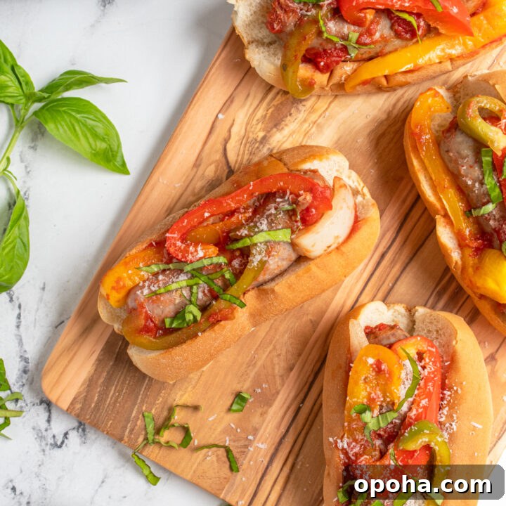 Overhead view of a bunch of sausages in buns on a cutting board.