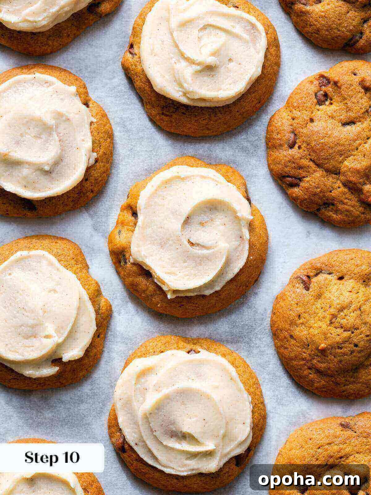 Pumpkin Chocolate Chip Cookie Recipe — Soft, Spiced & Gooey 12 A few freshly baked pumpkin chocolate chip cookies, some with a light swoosh of icing on top.
