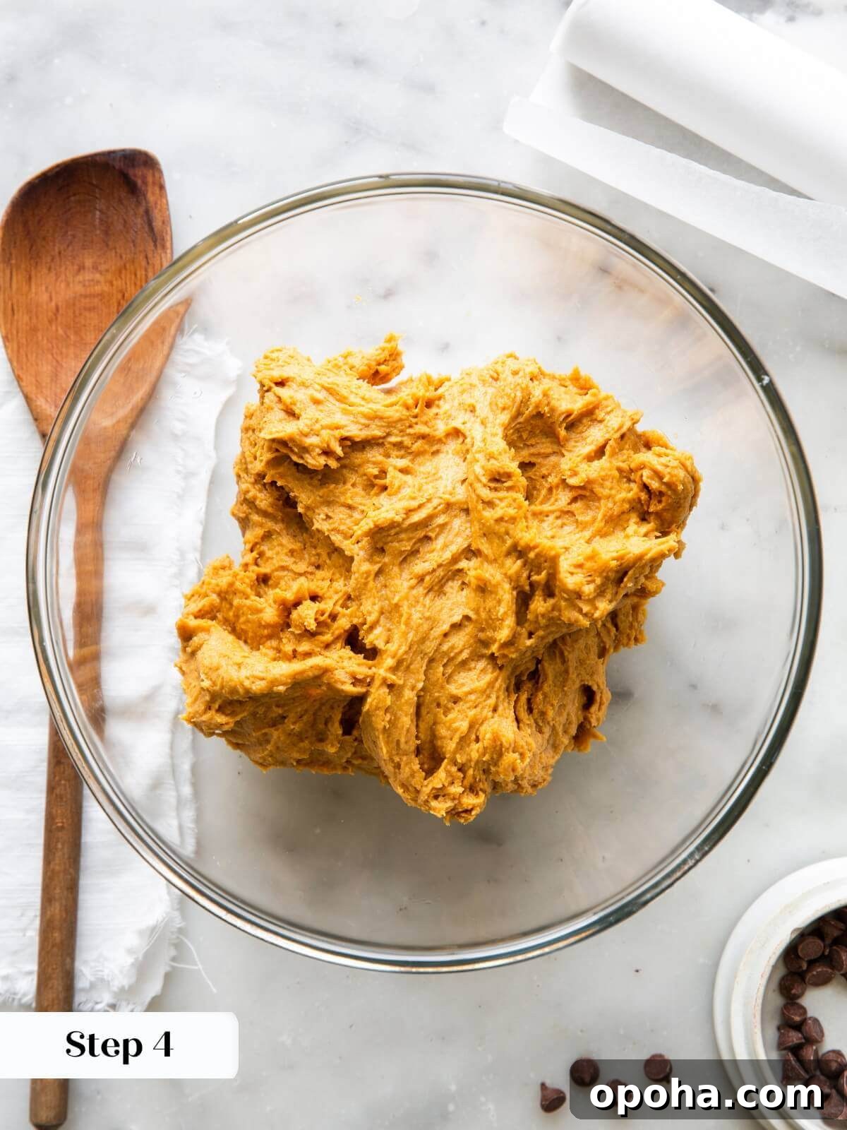 Pumpkin Chocolate Chip Cookie Recipe — Soft, Spiced & Gooey 8 The dough for pumpkin chocolate chip cookies being mixed, showing the smooth and slightly sticky texture.