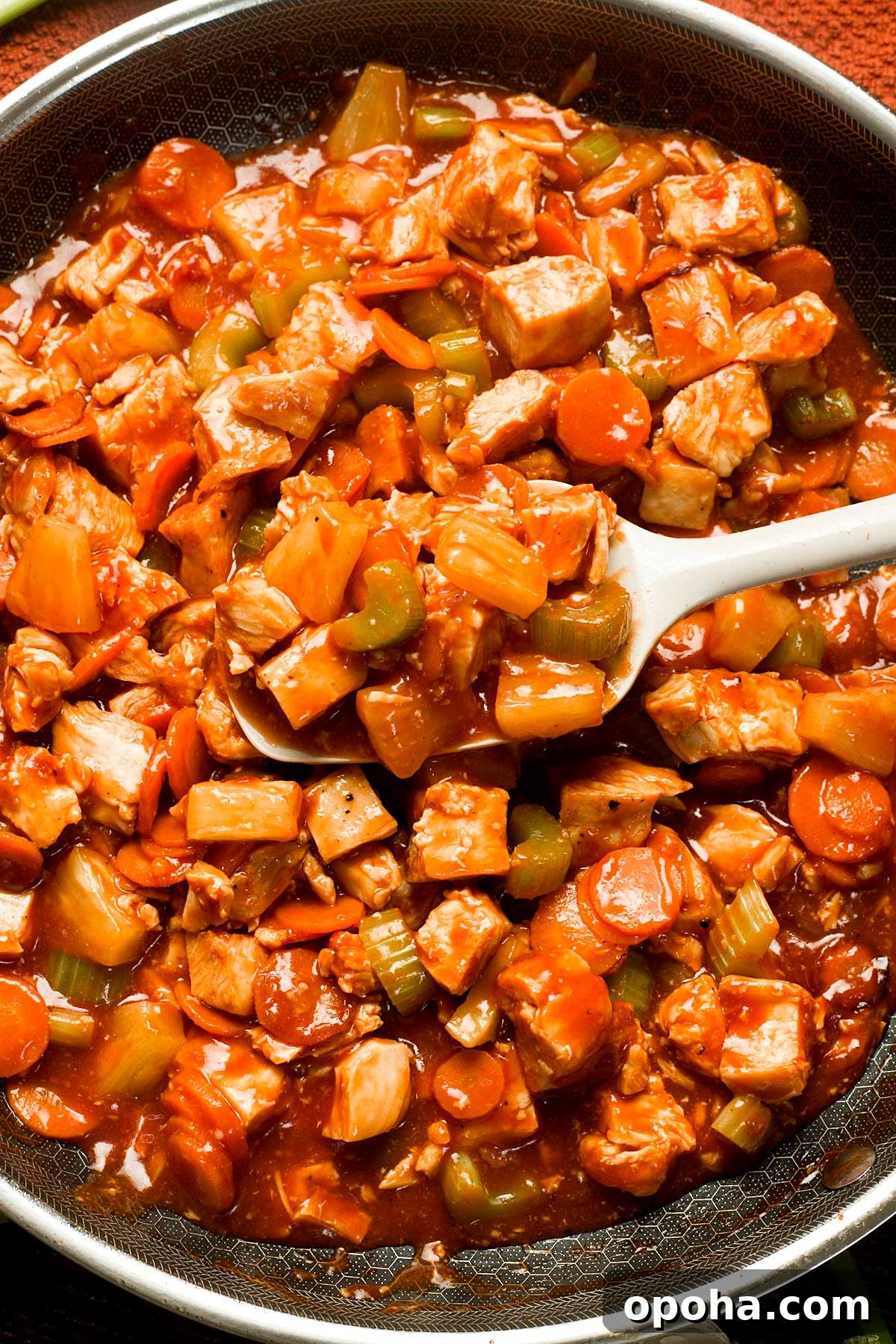 Gluten-Free Sweet and Sour Chicken Made in a HexClad Pan 11 Healthy Gluten-Free Sweet and Sour Chicken in a frying pan.
